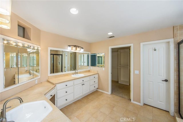 27470 Lakeview Dr, Helendale, CA 92342 - bathroom featuring double vanity, a stall shower, baseboards, recessed lighting, and a tub