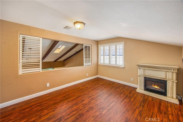 27470 Lakeview Dr, Helendale, CA 92342 - unfurnished living room featuring vaulted ceiling, wood finished floors, baseboards, and a glass covered fireplace