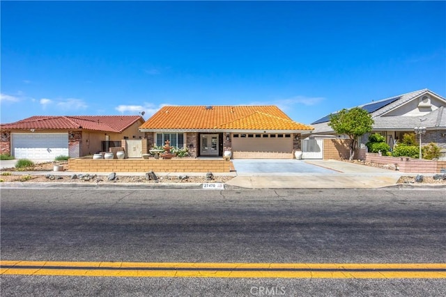27470 Lakeview Dr, Helendale, CA 92342 - view of front of property with an attached garage, a tiled roof, concrete driveway, and brick siding