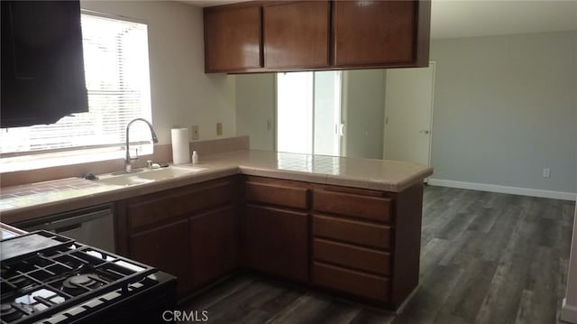 284 Celeste Dr, Riverside, CA 92507 - kitchen with black range with gas stovetop, tile countertops, a peninsula, and dark wood-style flooring