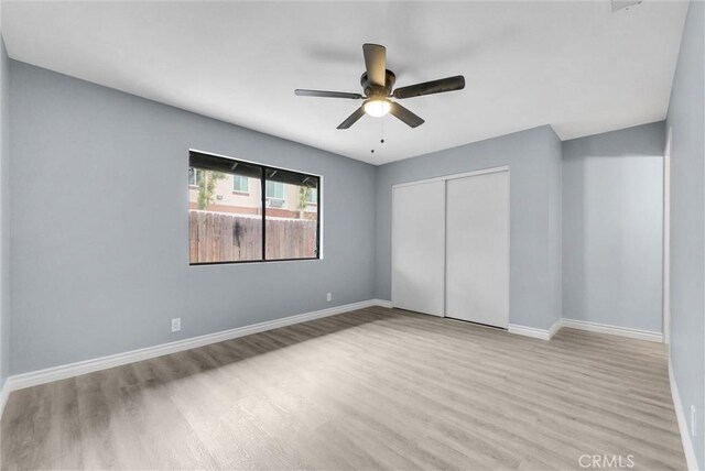 12830 Perris Blvd Unit C10, Moreno Valley, CA 92553 - unfurnished bedroom featuring wood finished floors, a closet, baseboards, and a ceiling fan