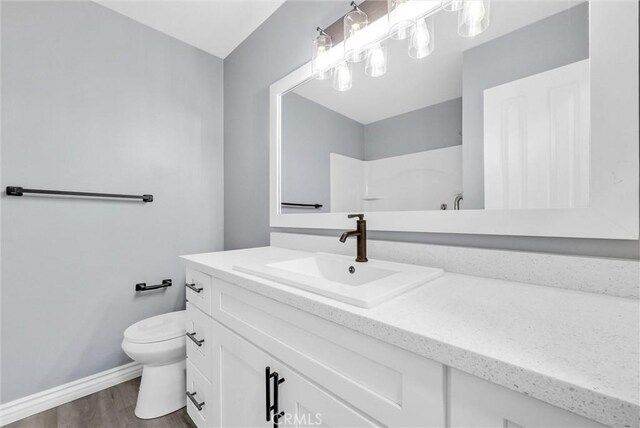 12830 Perris Blvd Unit C10, Moreno Valley, CA 92553 - full bathroom with toilet, vanity, baseboards, wood finished floors, and a shower
