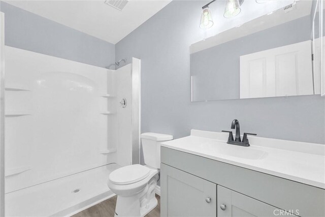 12830 Perris Blvd Unit C10, Moreno Valley, CA 92553 - full bath featuring vanity, a shower, wood finished floors, and toilet