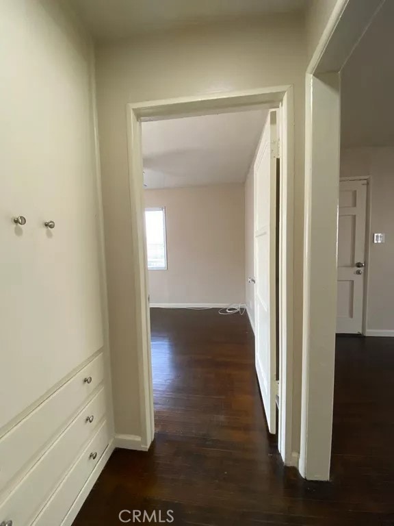 5631 Danny Ave, Cypress, CA 90630 - corridor featuring dark wood-style floors and baseboards