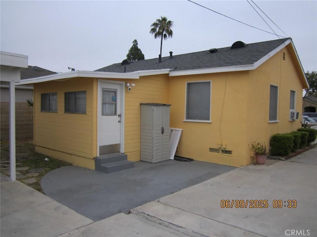 5631 Danny Ave, Cypress, CA 90630 - back of house featuring entry steps, a patio area, stucco siding, and roof with shingles