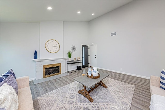 11591 Palawan St, Cypress, CA 90630 - living area with light wood-style flooring, recessed lighting, a premium fireplace, and high vaulted ceiling