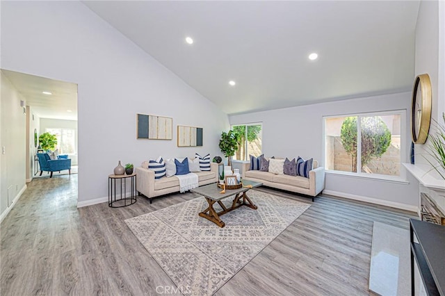 11591 Palawan St, Cypress, CA 90630 - living area featuring plenty of natural light, high vaulted ceiling, wood finished floors, and recessed lighting