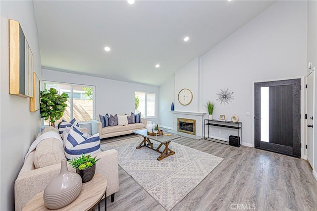 11591 Palawan St, Cypress, CA 90630 - living room featuring high vaulted ceiling, wood finished floors, a fireplace, and recessed lighting