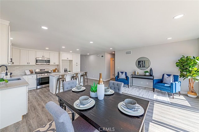 11591 Palawan St, Cypress, CA 90630 - dining room with light wood-style floors and recessed lighting