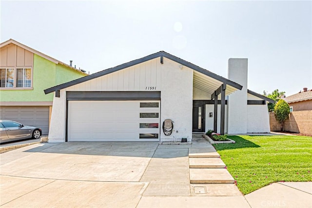 11591 Palawan St, Cypress, CA 90630 - mid-century modern home with an attached garage, driveway, and a front yard