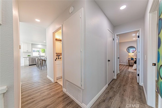 11591 Palawan St, Cypress, CA 90630 - hall with light wood-style flooring and recessed lighting