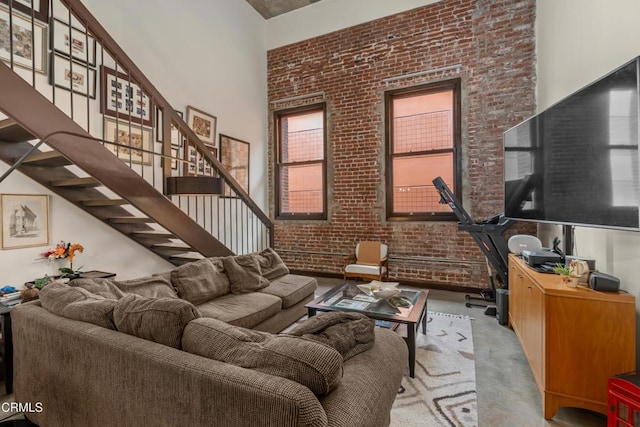 35 N Raymond Ave Unit 210, Pasadena, CA 91103 - living room with a high ceiling, brick wall, and stairs
