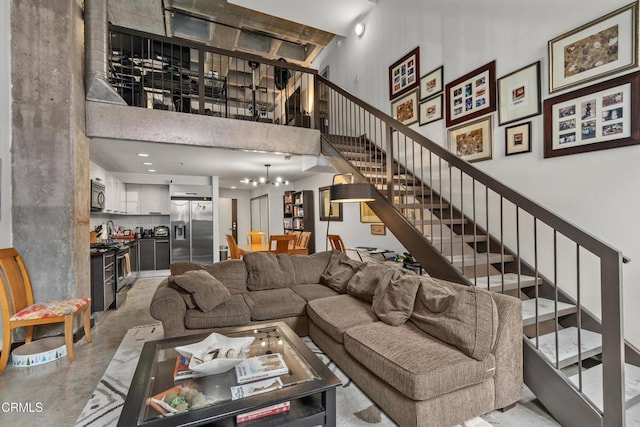 35 N Raymond Ave Unit 210, Pasadena, CA 91103 - living room with a high ceiling, stairs, and concrete flooring