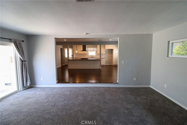 425 E Wilson Ave, Orange, CA 92867 - unfurnished living room with baseboards, dark colored carpet, and a sink