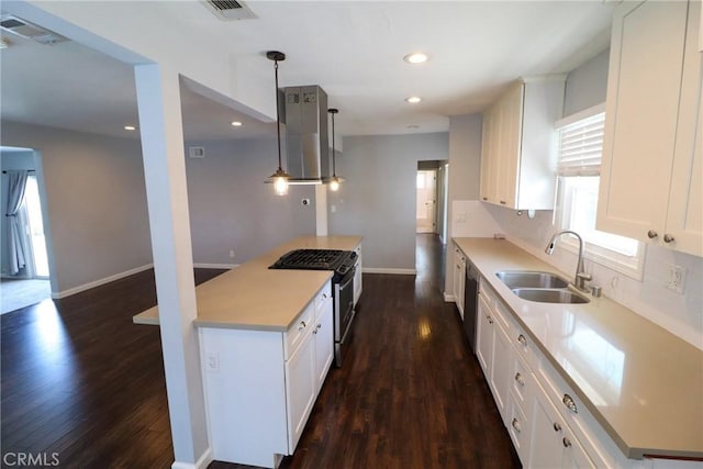 425 E Wilson Ave, Orange, CA 92867 - kitchen with stainless steel appliances, a sink, ventilation hood, a center island, and dark wood-style floors