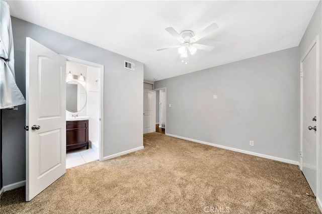 425 E Wilson Ave, Orange, CA 92867 - unfurnished bedroom with light carpet, connected bathroom, and ceiling fan