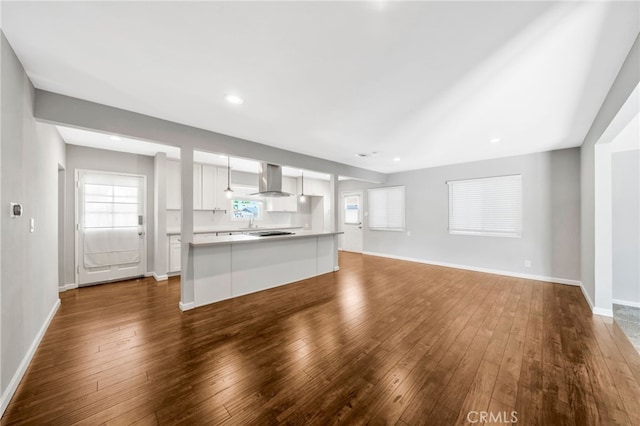 425 E Wilson Ave, Orange, CA 92867 - unfurnished living room with dark wood-style flooring and recessed lighting