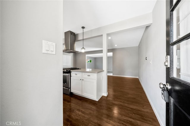 425 E Wilson Ave, Orange, CA 92867 - kitchen with stainless steel range with gas cooktop, wall chimney range hood, dark wood-type flooring, white cabinets, and hanging light fixtures