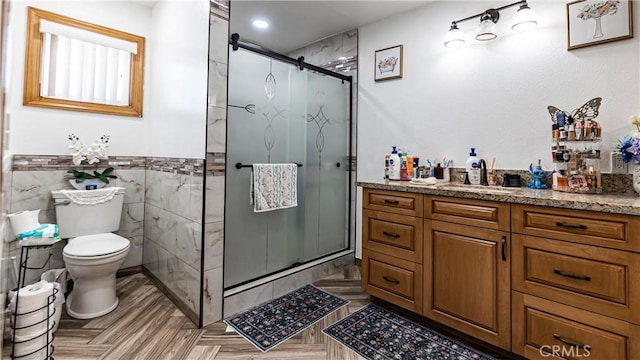 9828 Carob Ave, Fontana, CA 92335 - bathroom with a stall shower, vanity, tile walls, a wainscoted wall, and recessed lighting