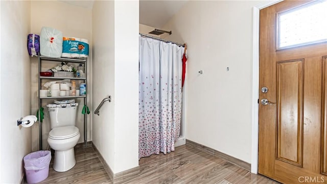 9828 Carob Ave, Fontana, CA 92335 - full bath featuring curtained shower and wood finished floors