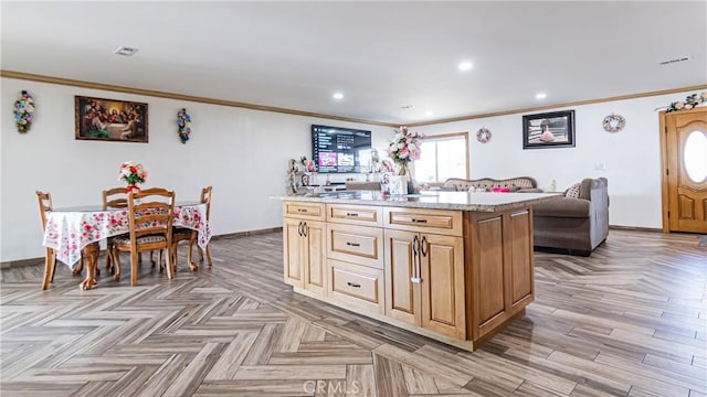 9828 Carob Ave, Fontana, CA 92335 - kitchen featuring ornamental molding, a kitchen island, light stone counters, recessed lighting, and open floor plan