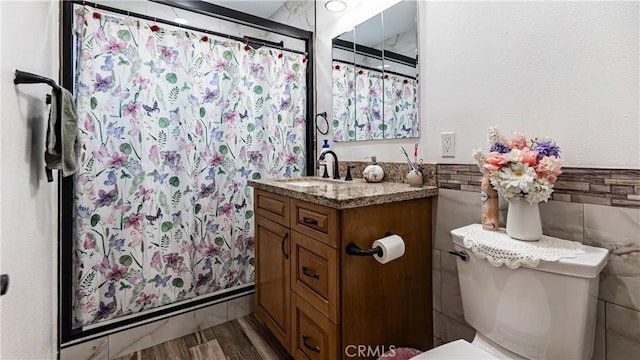 9828 Carob Ave, Fontana, CA 92335 - full bathroom with vanity, wood finished floors, curtained shower, and tile walls
