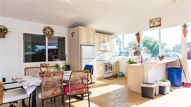 9828 Carob Ave, Fontana, CA 92335 - kitchen featuring white appliances, cream cabinets, light countertops, lofted ceiling, and a baseboard radiator