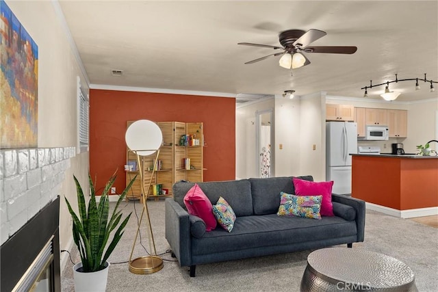 3030 Silverbell Rd, Chico, CA 95973 - living room with crown molding, light carpet, a ceiling fan, and a brick fireplace