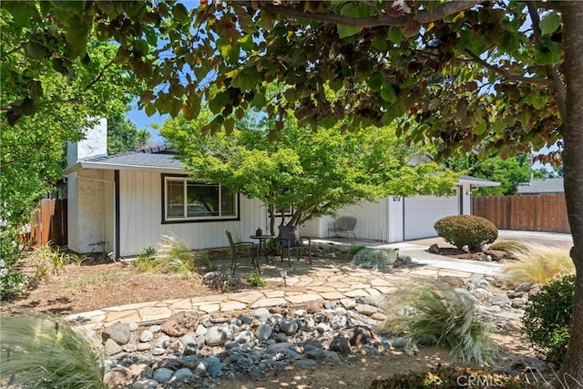 3030 Silverbell Rd, Chico, CA 95973 - view of property hidden behind natural elements with a chimney, a patio, and a garage