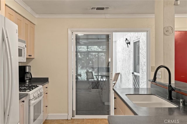 3030 Silverbell Rd, Chico, CA 95973 - kitchen with a sink, white appliances, dark countertops, ornamental molding, and light brown cabinets