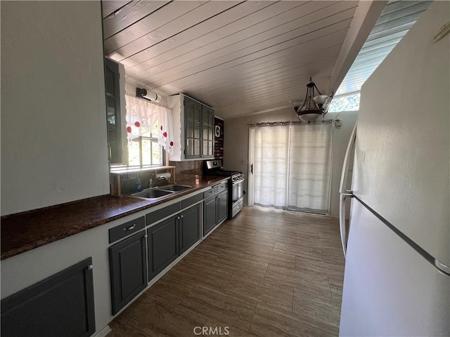 17139 E Newburgh St, Azusa, CA 91702 - kitchen with stainless steel gas range oven, freestanding refrigerator, a sink, and healthy amount of natural light