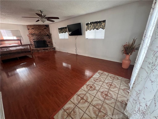 17139 E Newburgh St, Azusa, CA 91702 - unfurnished living room featuring ceiling fan, wood finished floors, a textured ceiling, and a fireplace