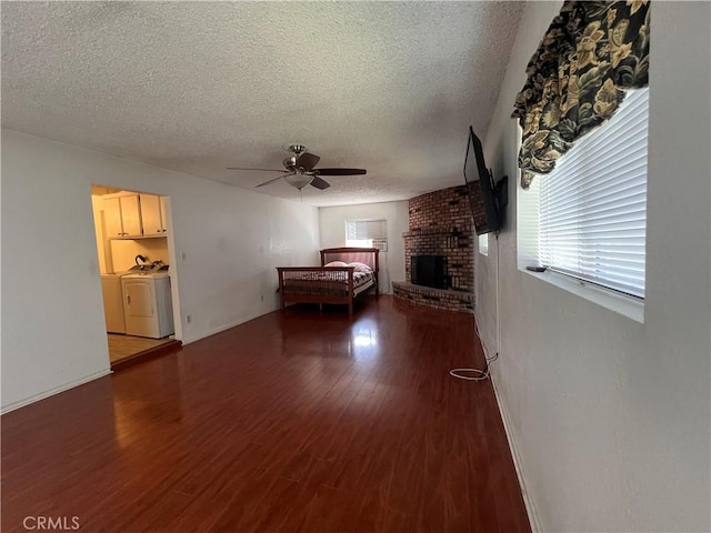 17139 E Newburgh St, Azusa, CA 91702 - living area with independent washer and dryer, a ceiling fan, a textured ceiling, wood finished floors, and a brick fireplace