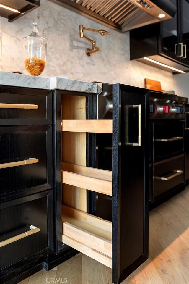 9363 Dinsdale St, Downey, CA 90240 - kitchen view of light wood-type flooring, pot filler, and custom exhaust hood