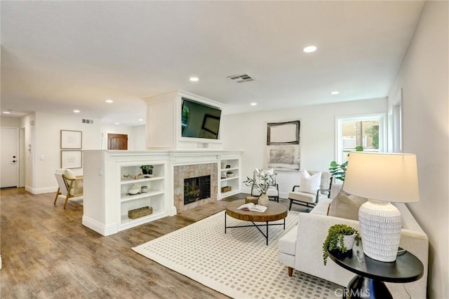 55 Fairfield, Lake Forest, CA 92610 - living area with wood finished floors, a tiled fireplace, and recessed lighting