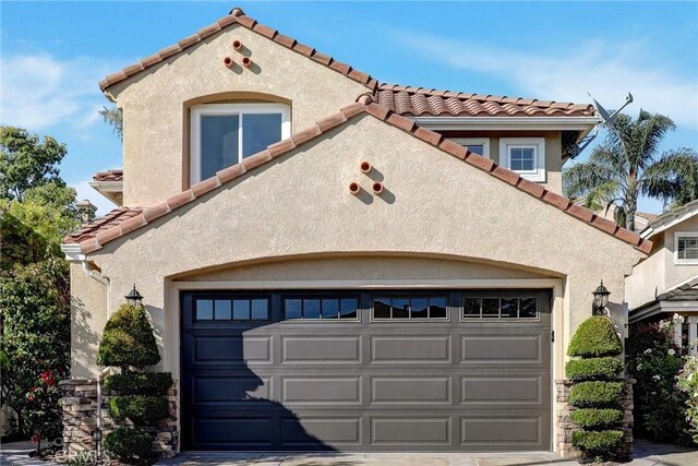 55 Fairfield, Lake Forest, CA 92610 - mediterranean / spanish-style house featuring a tile roof, stucco siding, and an attached garage