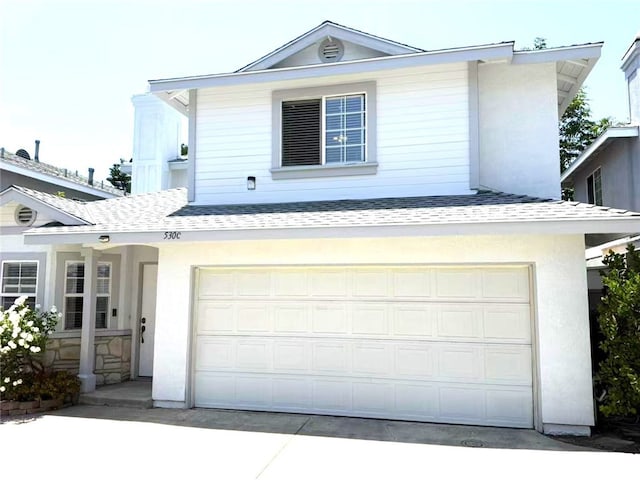 530 Diamond St Unit C, Monrovia, CA 91016 - view of front of house with roof with shingles, concrete driveway, an attached garage, and stucco siding
