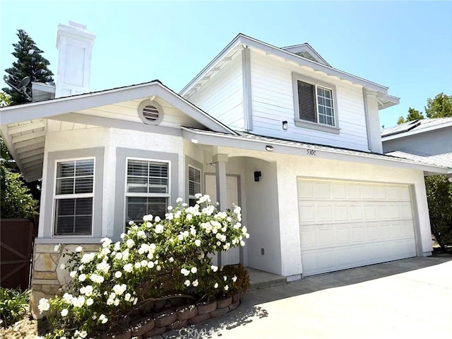 530 Diamond St Unit C, Monrovia, CA 91016 - view of front facade with an attached garage, driveway, stucco siding, and a chimney