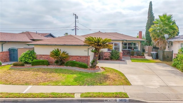 14012 S Wilkie Ave, Gardena, CA 90249 - view of front of property featuring brick siding, stucco siding, and a gate