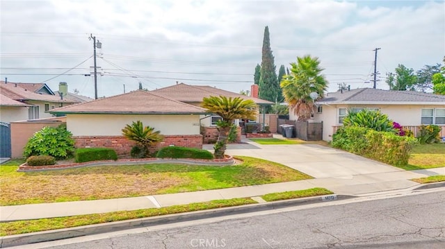 14012 S Wilkie Ave, Gardena, CA 90249 - single story home with brick siding, concrete driveway, and stucco siding