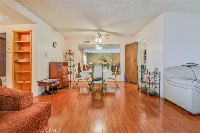 14012 S Wilkie Ave, Gardena, CA 90249 - sitting room with a textured ceiling, wood finished floors, a ceiling fan, and built in features
