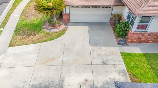 14012 S Wilkie Ave, Gardena, CA 90249 - view of front of home with brick siding, concrete driveway, and stucco siding
