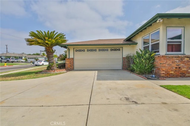 14012 S Wilkie Ave, Gardena, CA 90249 - view of home's exterior featuring driveway, an attached garage, brick siding, and stucco siding