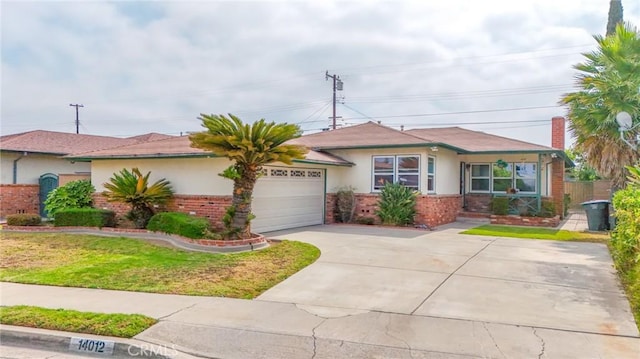 14012 S Wilkie Ave, Gardena, CA 90249 - view of front of home featuring brick siding, an attached garage, concrete driveway, and stucco siding