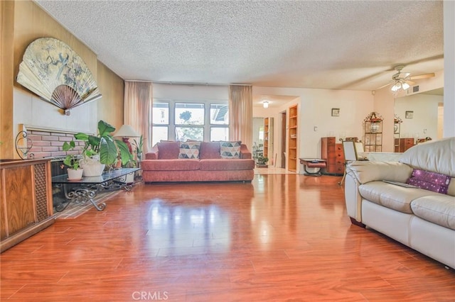 14012 S Wilkie Ave, Gardena, CA 90249 - living area with a textured ceiling, wood finished floors, and ceiling fan