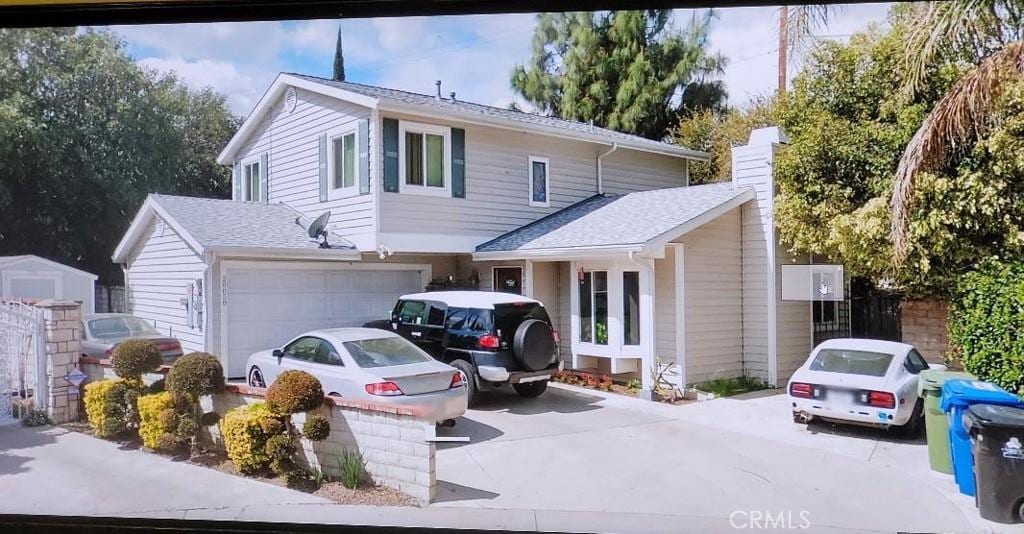 20058 Lorne St, Winnetka, CA 91306 - traditional-style home with concrete driveway, a garage, roof with shingles, and a chimney