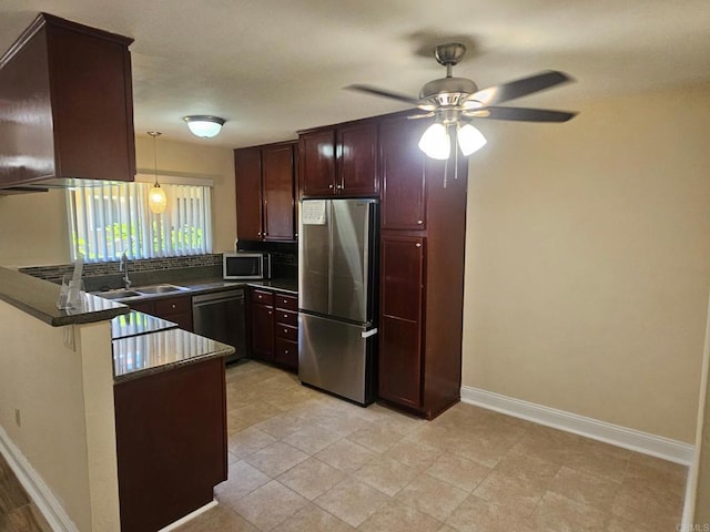 12805 Mapleview St Unit 14, Lakeside, CA 92040 - kitchen with stainless steel appliances, a sink, a peninsula, dark countertops, and a ceiling fan