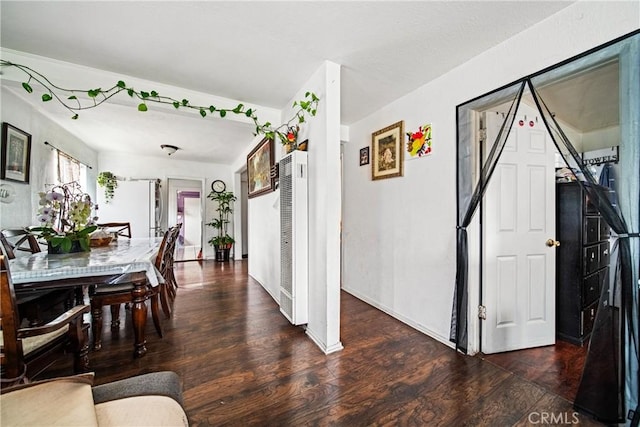 633 E 136th St, Los Angeles, CA 90059 - dining room featuring a heating unit and wood finished floors