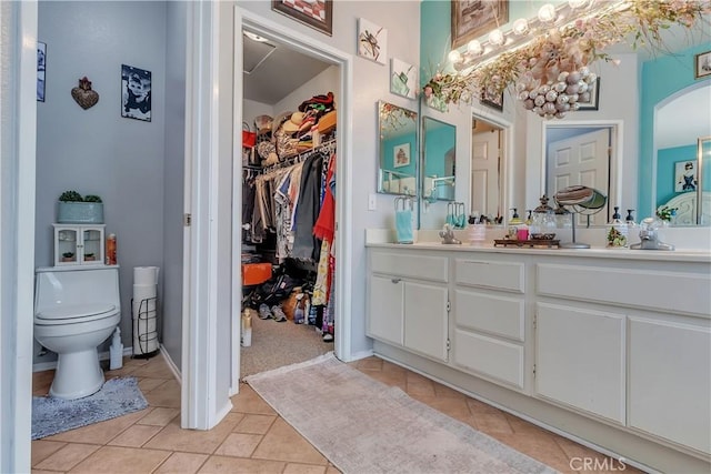 11244 Sega Ln, Fontana, CA 92337 - full bath featuring double vanity, tile patterned flooring, and a walk in closet