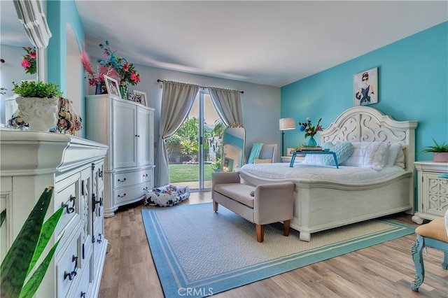 11244 Sega Ln, Fontana, CA 92337 - bedroom featuring access to exterior and wood finished floors